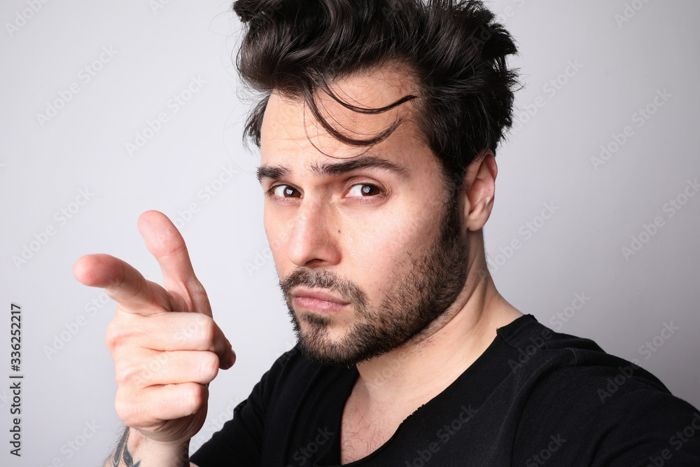 Handsome and bearded hipster making fun posing on white wall.Isolated. Handsome and bearded hipster making fun posing on white wall.Isolated.