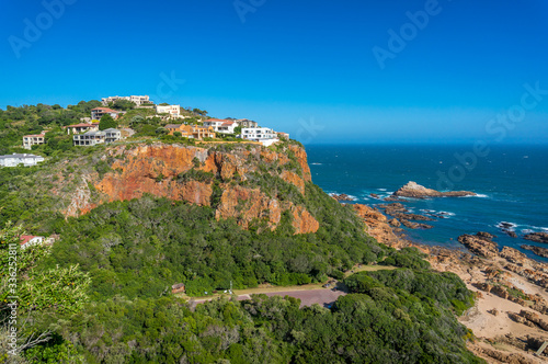 Beautful view of luxury waterfront properties on a cliff surrounded by nature