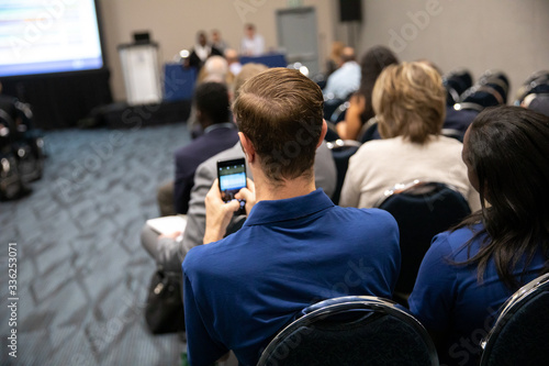 Man taking photo in conference room