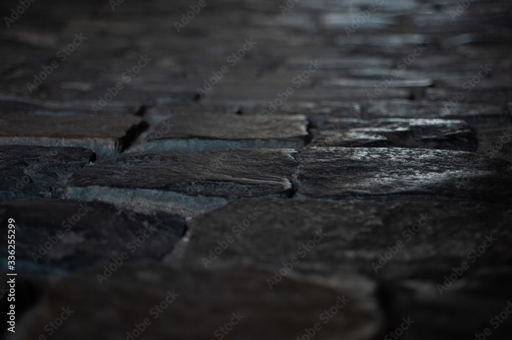 background texture old road from large old stones leaves in perspective background texture old road from large old stones leaves in perspective