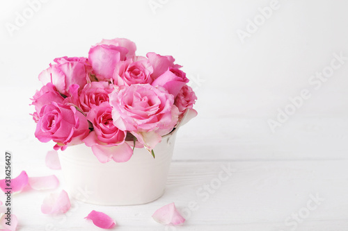 flowers in a vase. pink roses on white background
