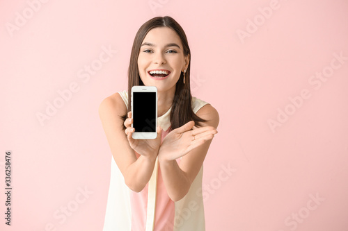 Happy young woman with mobi...