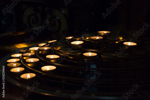 Burning candles in Church on black background