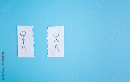 Two people drawn on pieces of paper lie next to each other. The concept of self-isolation. Coronavirus, stop the spread of infection. 2019-ncov