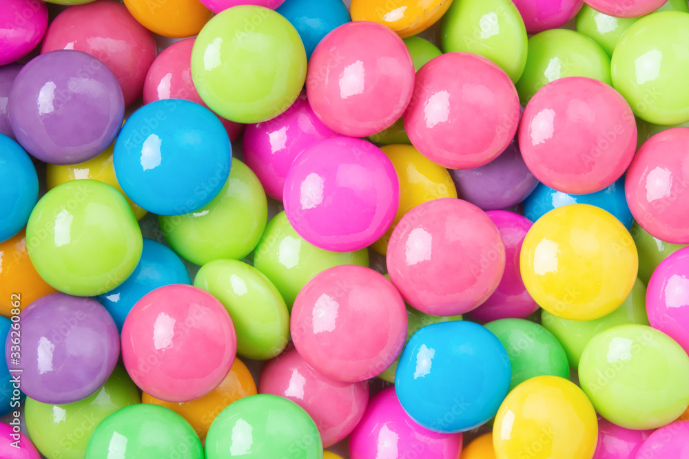 Pile of colorful sweet candy chocolates coated on white paper. colourful collection background. Pile of colorful sweet candy chocolates coated on white paper. colourful collection background.