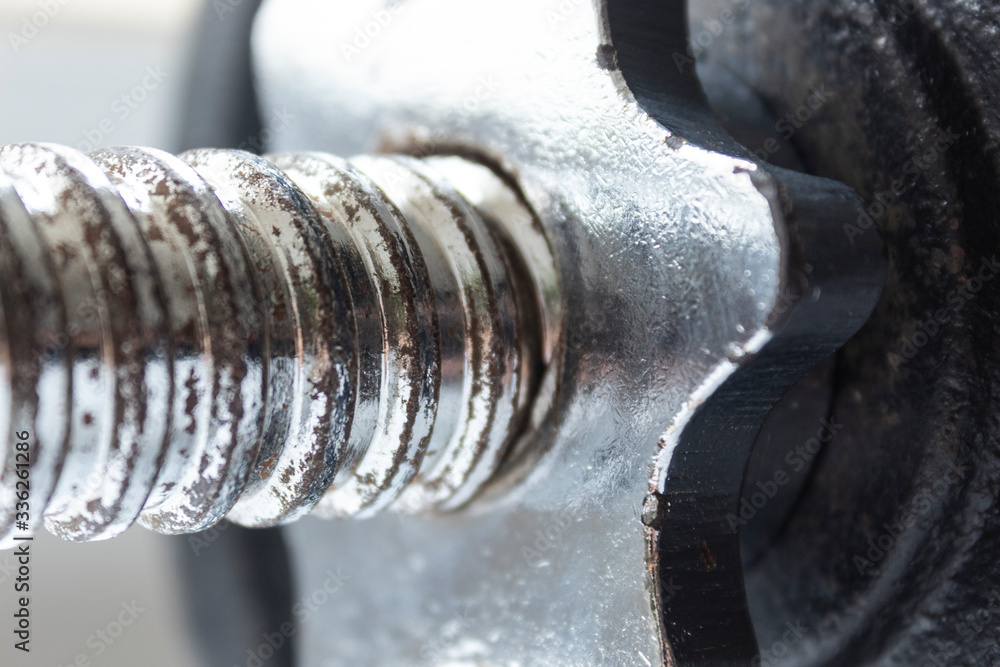 Macro photography to an iron bar and gear of dumbell. Ideal for fitness, sports, and healthy life. Macro photography to an iron bar and gear of dumbell. Ideal for fitness, sports, and healthy life.