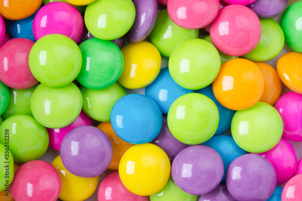 Pile of colorful sweet candy chocolates coated on white paper. colourful collection background. Pile of colorful sweet candy chocolates coated on white paper. colourful collection background.