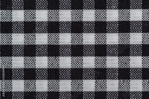 Checkered fabric background. Black cell. Top view, flat lay