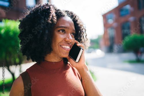 Smiling black woman making call in street