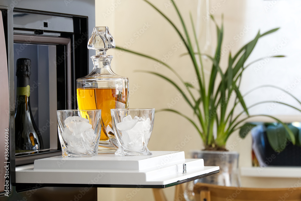 open hatch of a mini bar in a modern refrigerator. home mini bar in the