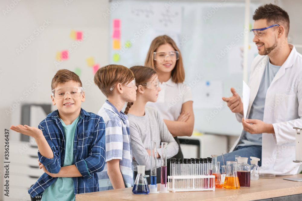 Teacher conducting chemistry lesson in classroom