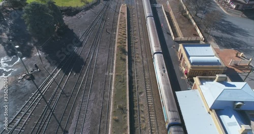 Aerial video of a train leaving an old country station shot in cinema 4k 