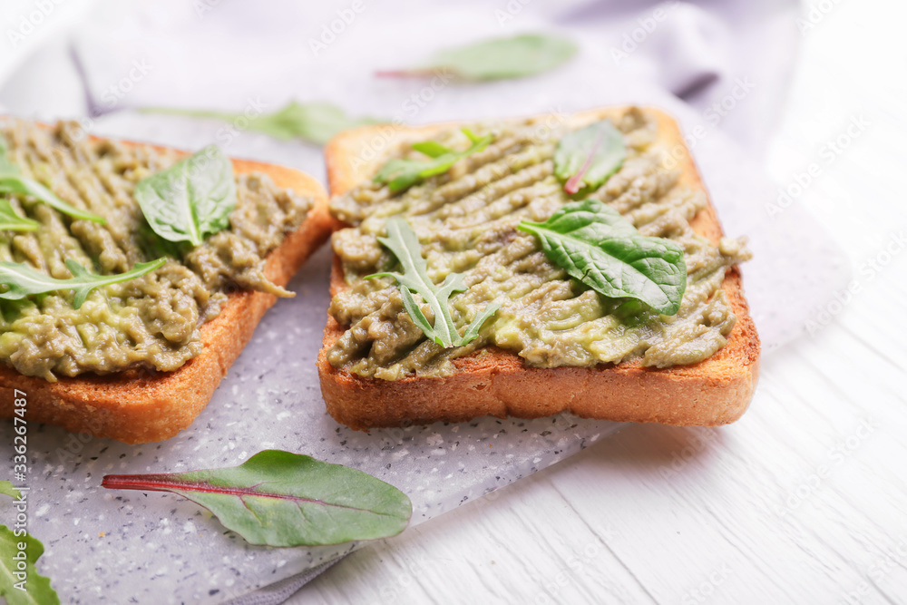 Tasty avocado sandwiches on table Tasty avocado sandwiches on table