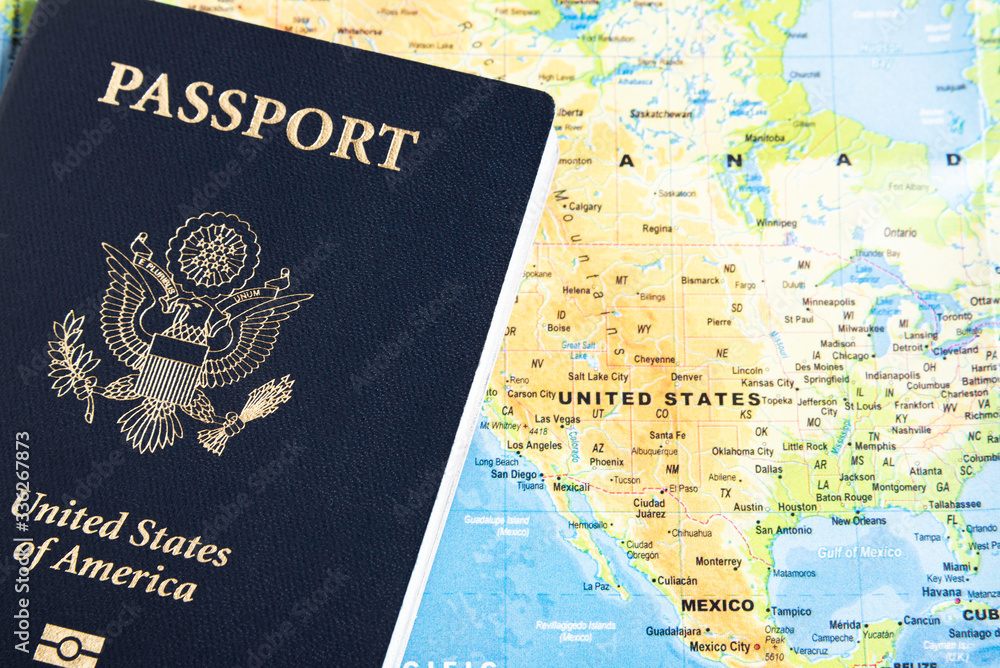 The foil-stamped dark blue front cover of an American passport set on a world map background. The foil-stamped dark blue front cover of an American passport set on a world map background.