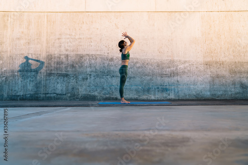 Young brunette making Prayer hands yoga pose on fitness mat © BullRun