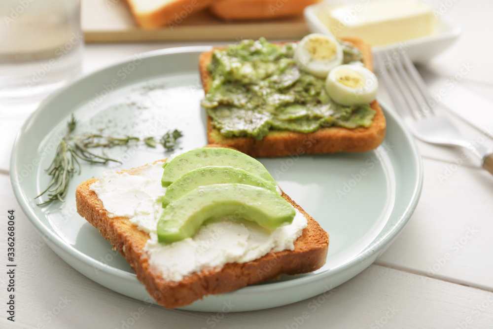 Tasty avocado sandwiches on plate