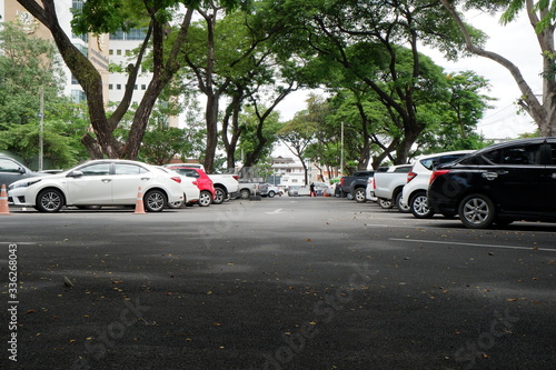 Aerial parking lot outdoors vehicles green park.