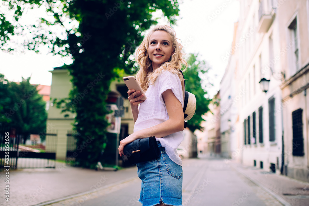 Joyful female walking in town in summertime Joyful female walking in town in summertime