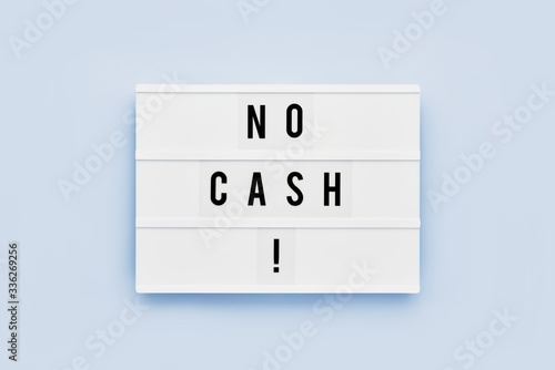 NO CASH written in light box on blue background. Motivation quote. Top view.