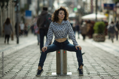 Beautiful asian woman posing in the center of Porto in Santa Catarina pedestrian street, Portugal. photo