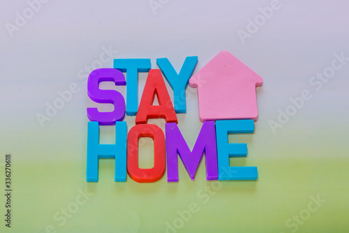 plastic letters with the phrase stay home - together photo