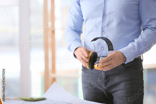 Male builder with headphone...