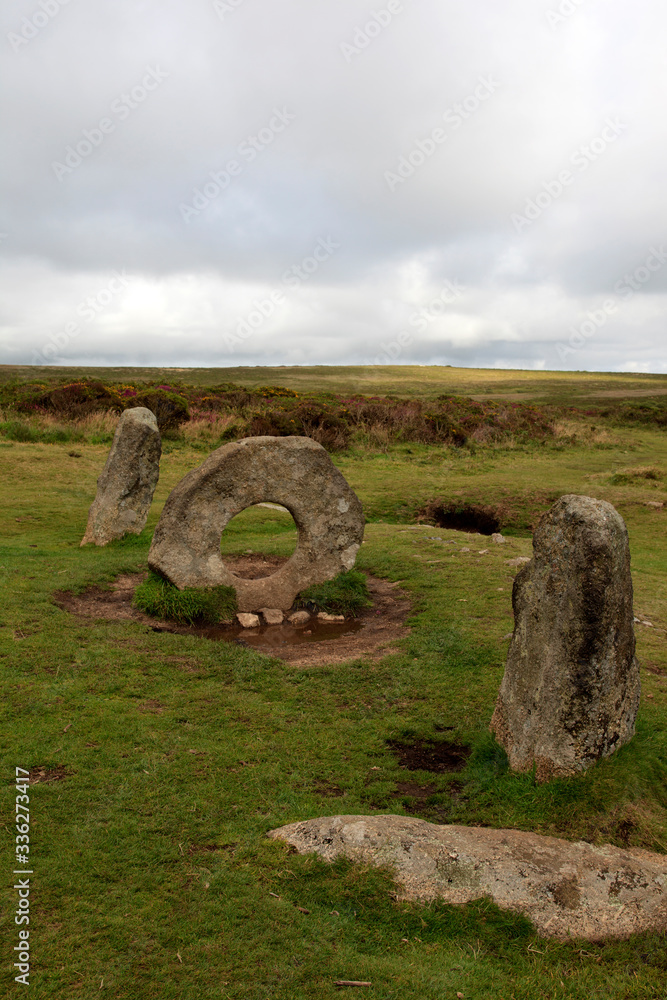 Madron (England), UK - August 16, 2015: A tourist near The famous Mên-an-Tol a Megalithic stone and Tomb near Madron, West Penwith, Cornwall, England, United Kingdom.