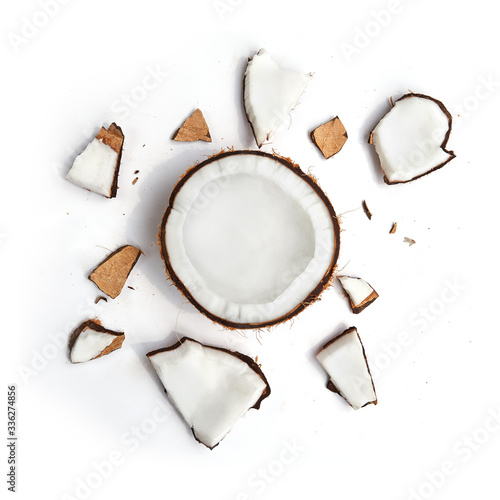 Whole coconut and pieces of coconut on white background photo