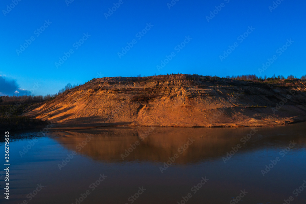 A beautiful image of nature. High sandy mountain and blue sky with deep clouds.