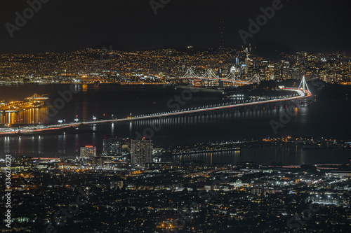 Bay Area California night view from Grizzly Peak. San Francisco  Oakland  Alameda  Berkeley  Bay Bridge and Sutro Tower. City skyline long exposure with water reflections.