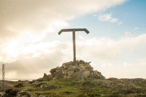 Metal Tau Cross on a Cairn Overlooking Tory Island, County Donegal, Ireland photo