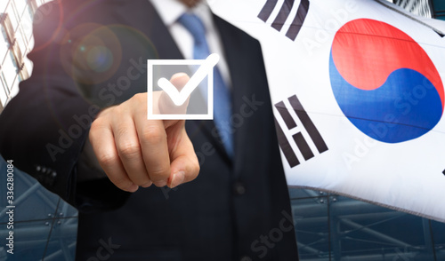 South Korea election concept. A businessman's election campaign against the backdrop of a Korean flag.