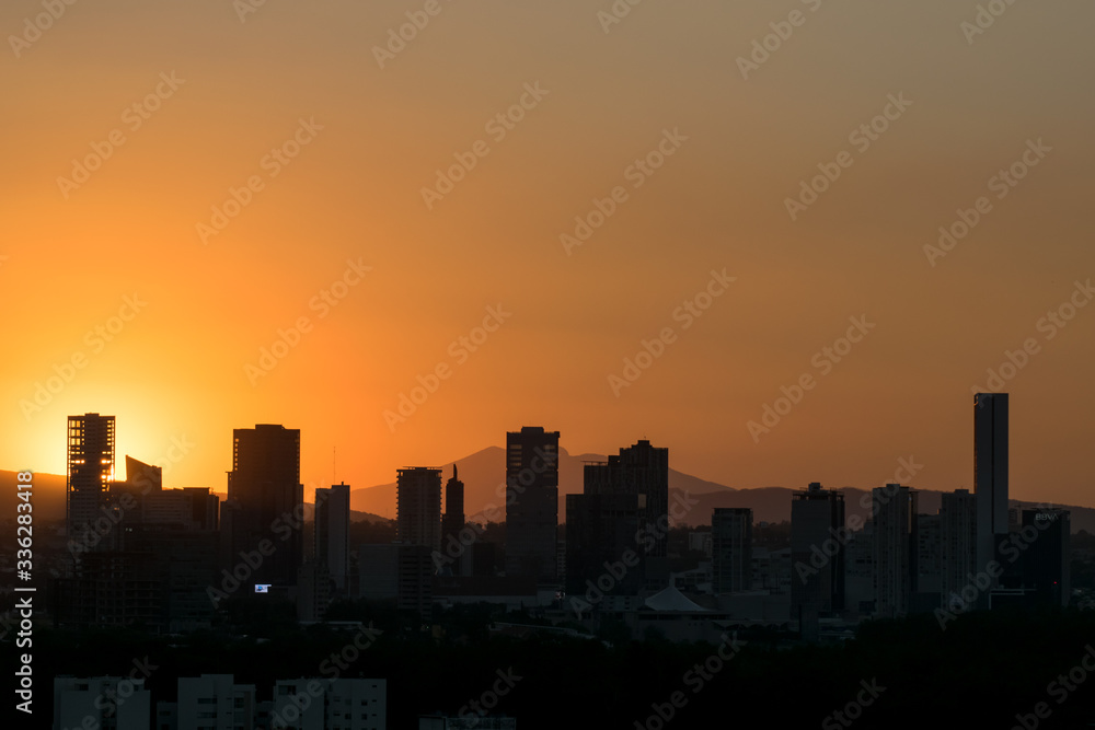 Sunset over city silhouette with clear sky