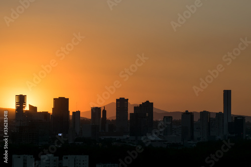 Sunset over city silhouette with clear sky