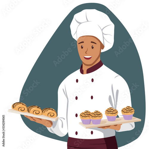 Smiling Chef holds a Baking Tray with Buns 