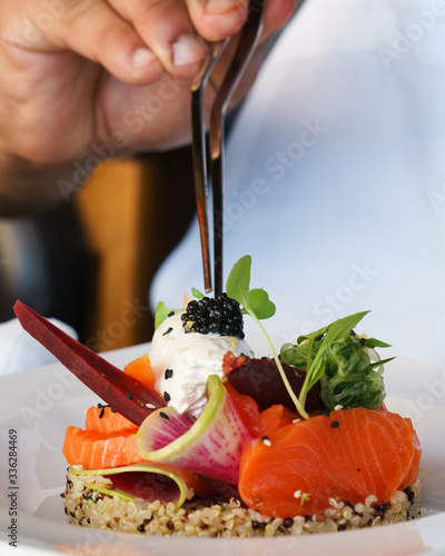 Fotografie chef tweezers plating lox salmon brunch dish