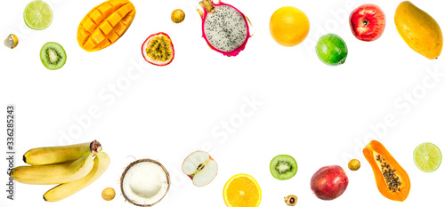 Creative layout made of passion fruit, pitahaya, mango, orange, papaya, coconut, longa, bananas, apples, kiwi, lime. Food summer concept.