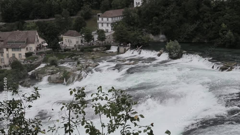 Massive streams of water at a waterfall in Schaffhausen on the river Rhine Massive streams of water at a waterfall in Schaffhausen on the river Rhine