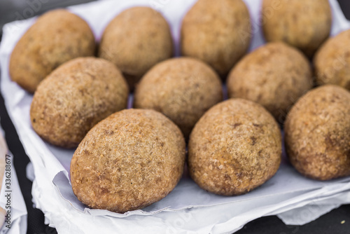 Close up photo of croquette cake at a street food market fair festival