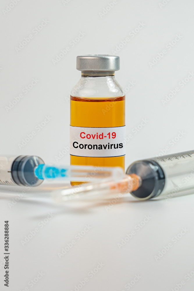 Vertical photo of Coronavirus vaccine bottle and syringe injection Vertical photo of Coronavirus vaccine bottle and syringe injection