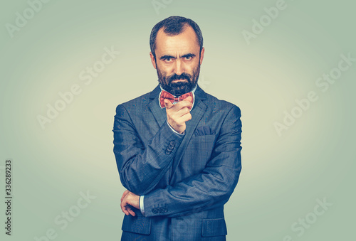 angry young man pointing finger at you camera