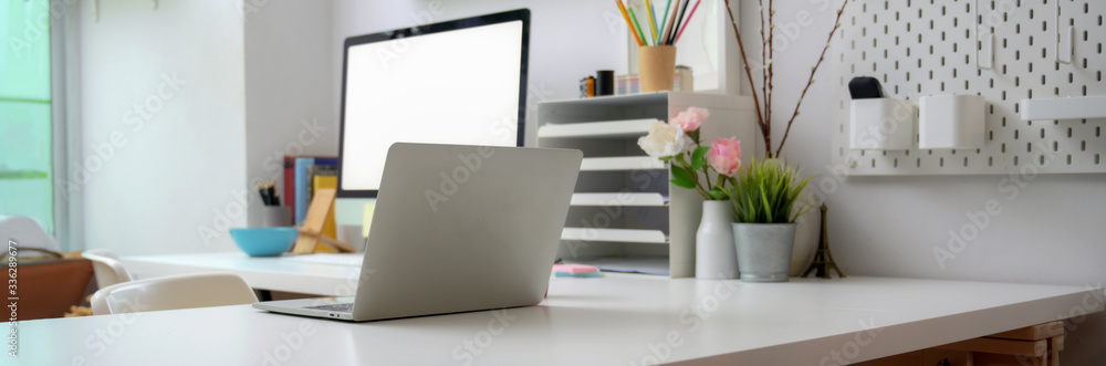 Cropped shot of simple office desk with with blank screen computer on white table Cropped shot of simple office desk with with blank screen computer on white table