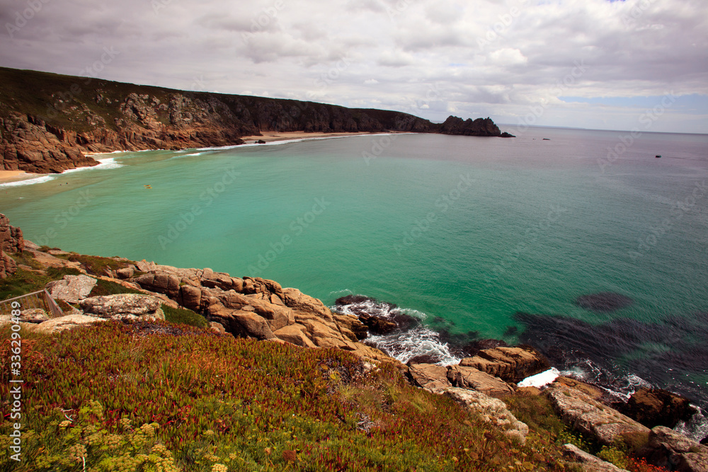 Porthcurno (England), UK - August 16, 2015: Porth Chapel beach, Porthcurno, Cornwall, England, United Kingdom. Porthcurno (England), UK - August 16, 2015: Porth Chapel beach, Porthcurno, Cornwall, England, United Kingdom.