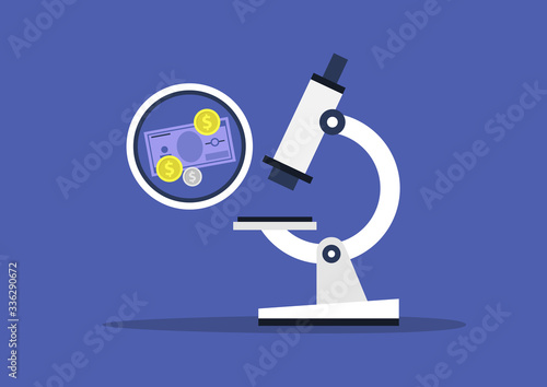 Money devaluation, economic crisis, global recession, paper currency and coins under the microscope glass