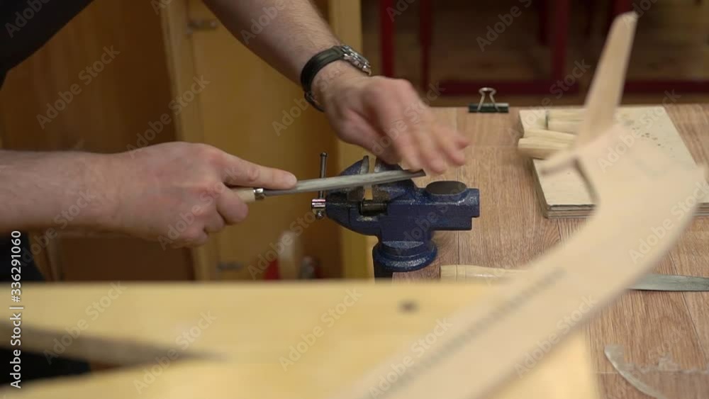 man hands polish plexiglass flight deck and match with brown wooden fuselage of jetliner model in workshop close view man hands polish plexiglass flight deck and match with brown wooden fuselage of jetliner model in workshop close view