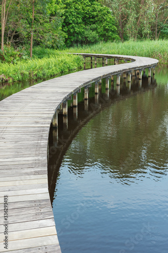 Rural landscape. Wooden bridge across river. Natural background