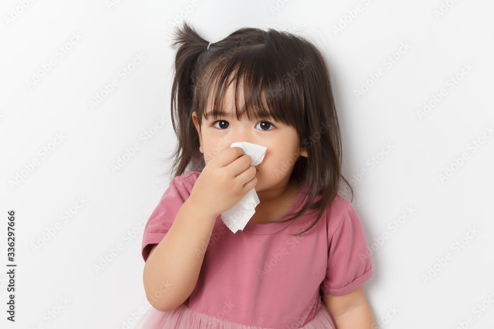 Little asian girl holding a tissue and blow her nose. Kid with cold rhinitis. virus and infection. Coronavirus symptom Little asian girl holding a tissue and blow her nose. Kid with cold rhinitis. virus and infection. Coronavirus symptom