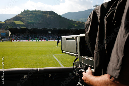 TV camera recording football game, photo