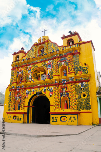 The picturesque church of El Calvario is located in San Andres Xecul, Totonicapan Guatemala.Built on the XVII century its architecture and details of the facade represent saints, animals, fruits photo