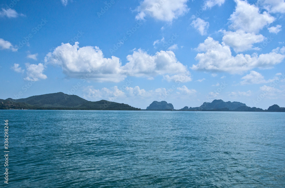 Beautiful cloudy sky over islands in blue sea